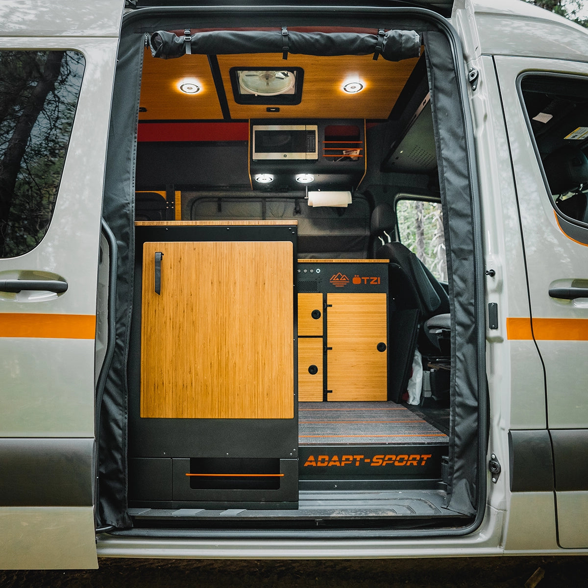 4x4 off‑road camper van splashing through a muddy trail on a weekend adventure van trip