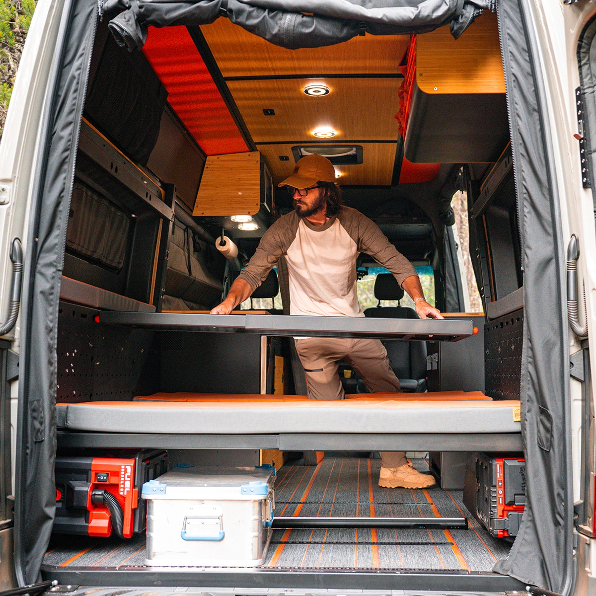 Off‑road camper van storage system with modular crates, pull‑out drawers, and room for outdoor gear