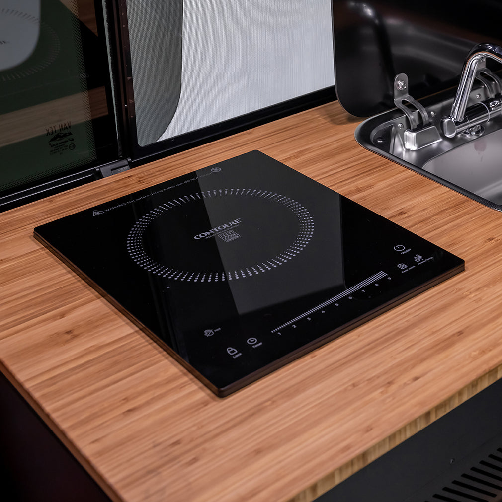 Off‑road camper van set up at a cliffside campsite with panoramic ocean views for vanlife camping