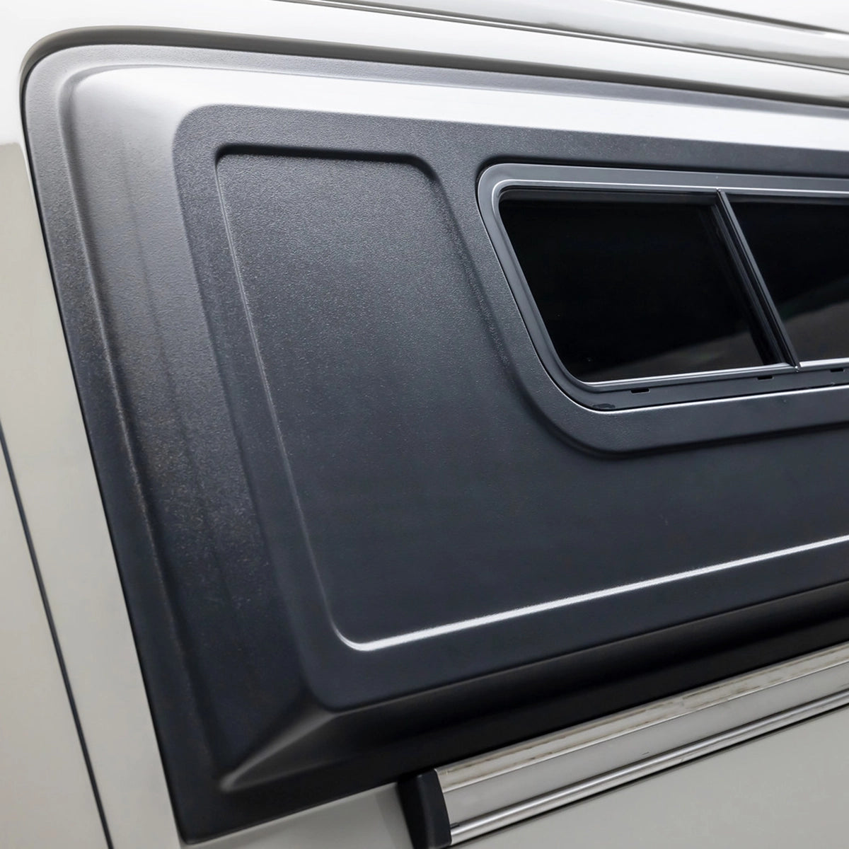 Vanlife interior with front seats turned toward a small dining table in an off‑road adventure van