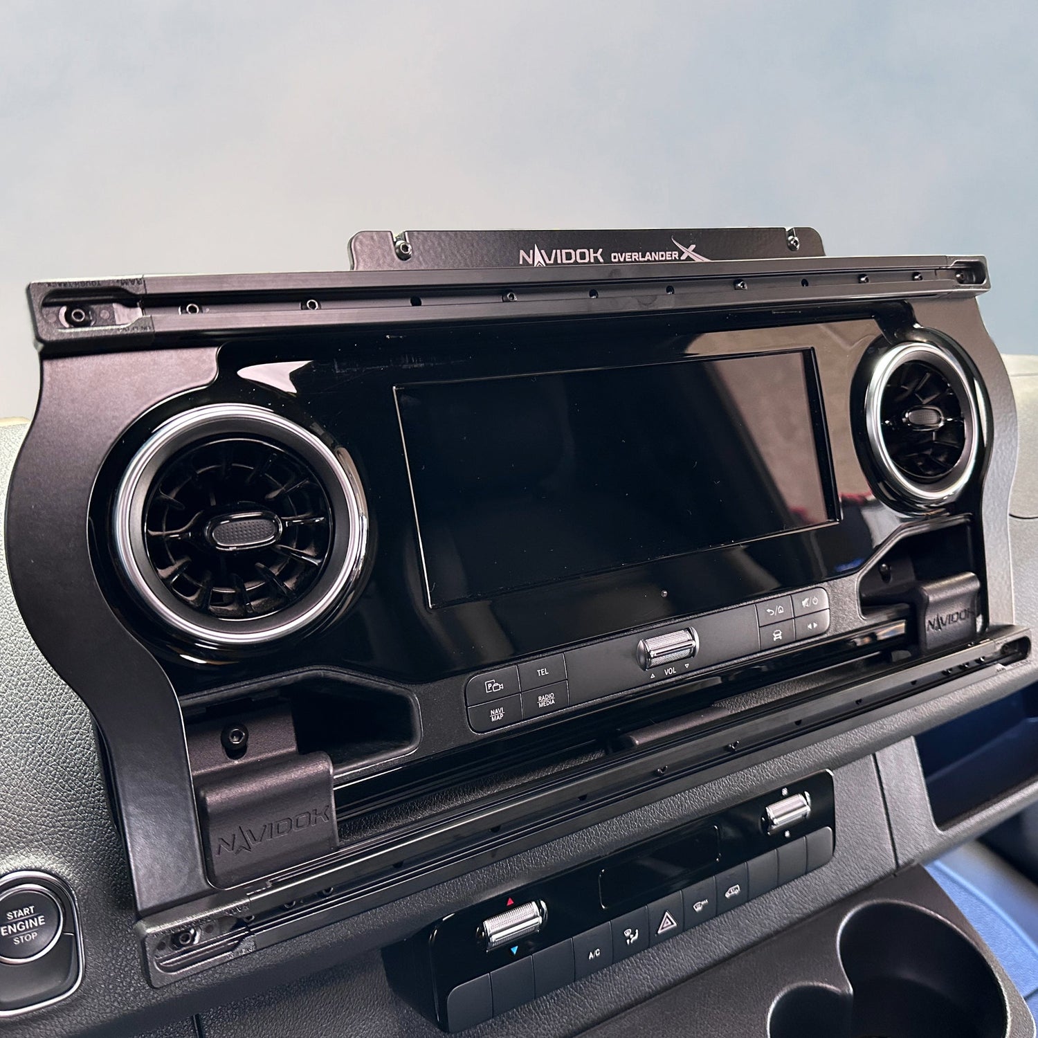 Navidok dash mount installed above in-dash display in a vehicle interior