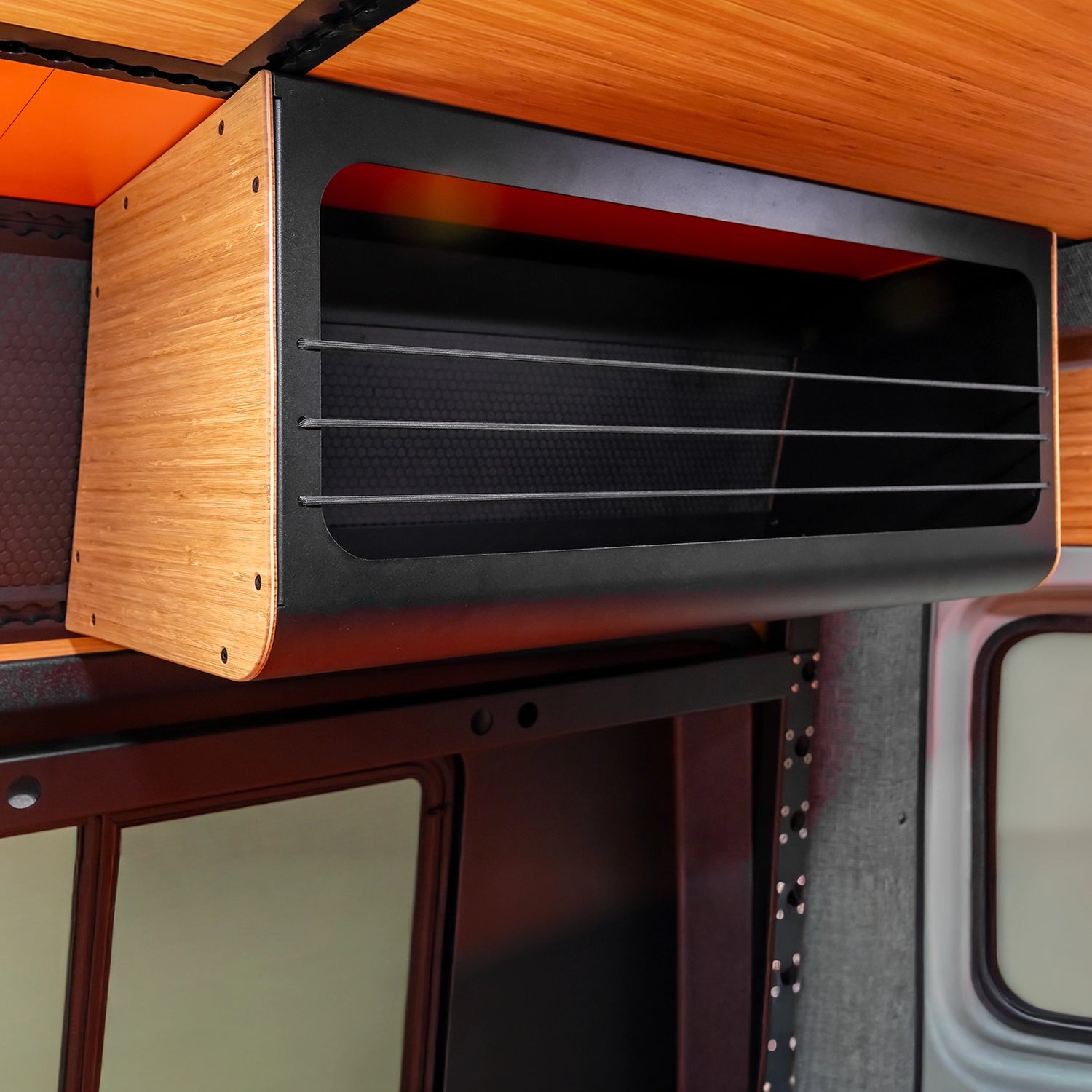 Boutique adventure van builder’s off‑road camper van on display at a mountain campsite