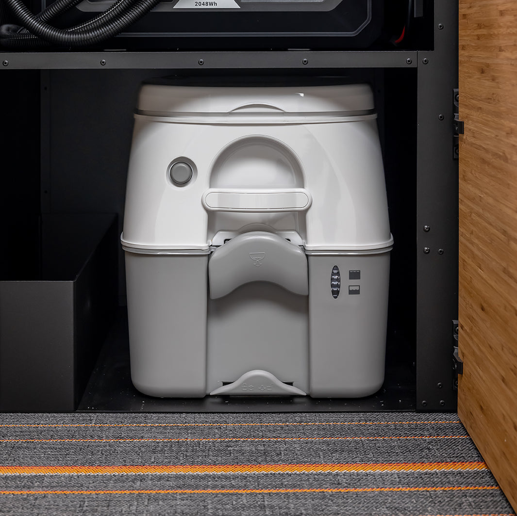 Overland adventure van kicking up dust on a remote desert road during an off‑grid camping trip