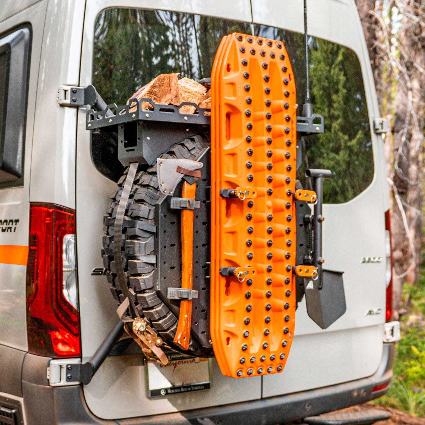 Lifted off‑road camper van turning onto a rocky mountain pass during a vanlife road trip