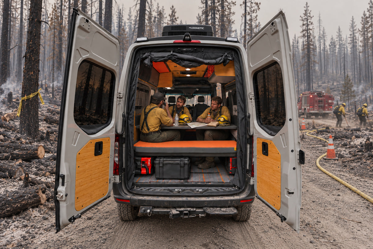 Wildland fire crew seated at the rear table inside an Otzi response vehicle during mop-up operations
