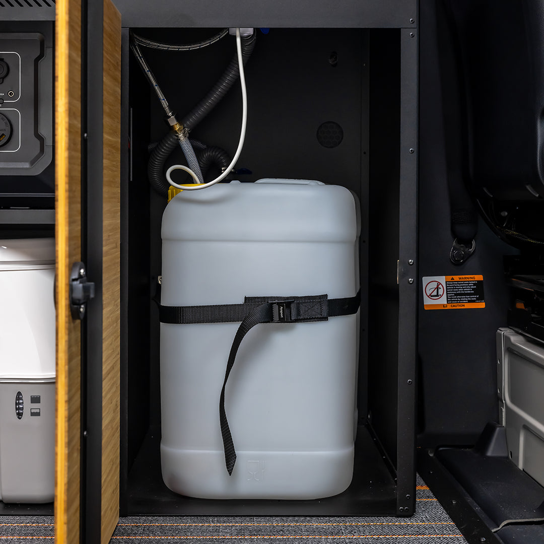 Rugged off‑road adventure van parked beside a river after a long backcountry drive