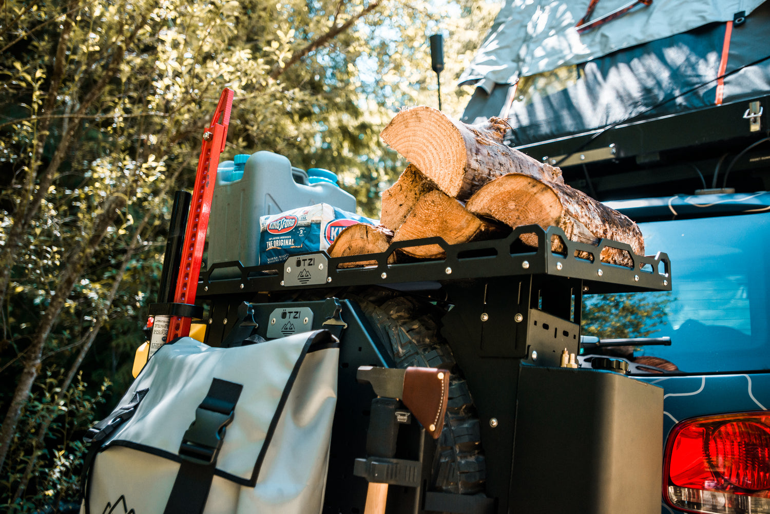 Off-road vehicle with gear rack carrying firewood, tools, and camping supplies
