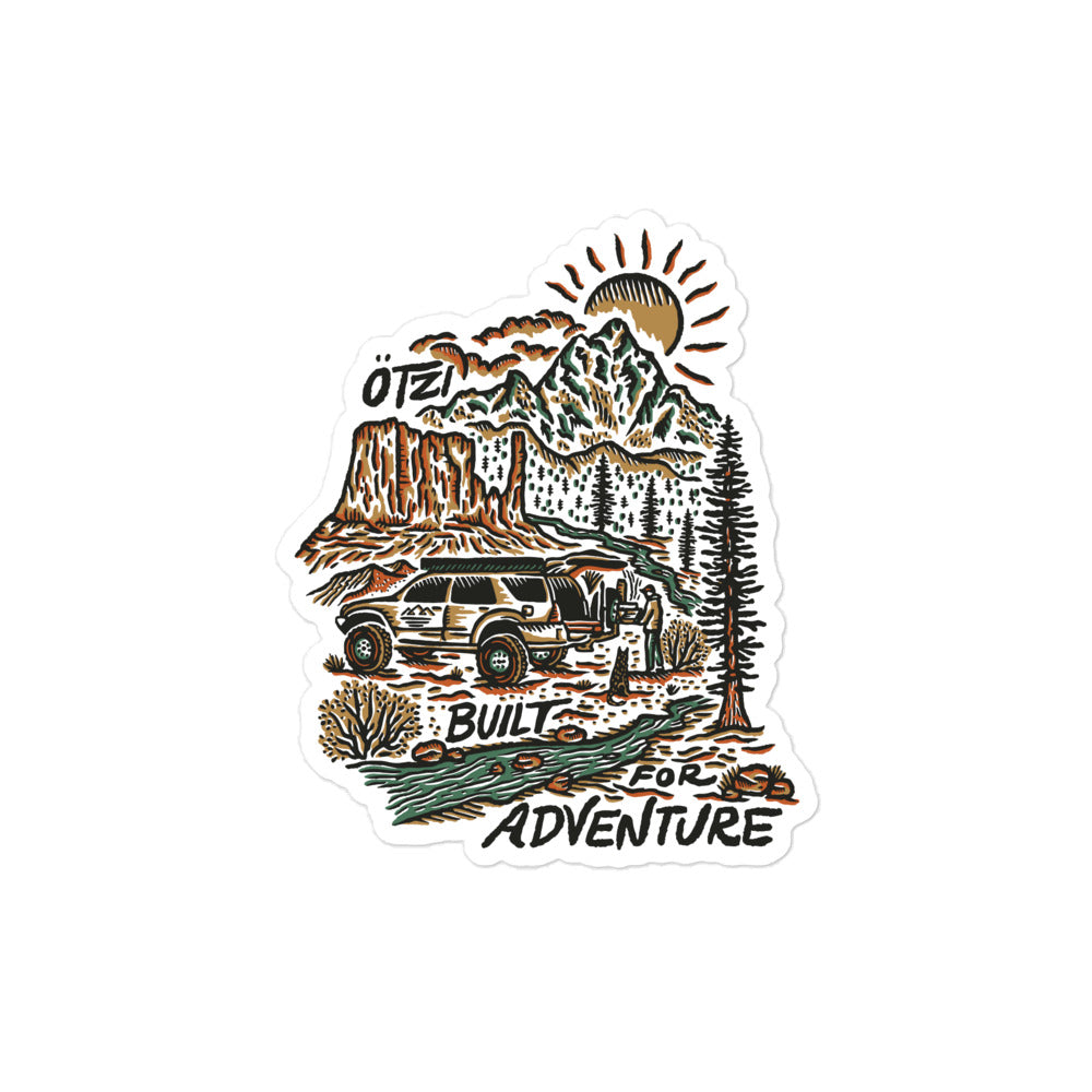 Sticker of an SUV in a mountain landscape with trees, sun, and text reading 'Built for Adventure'.