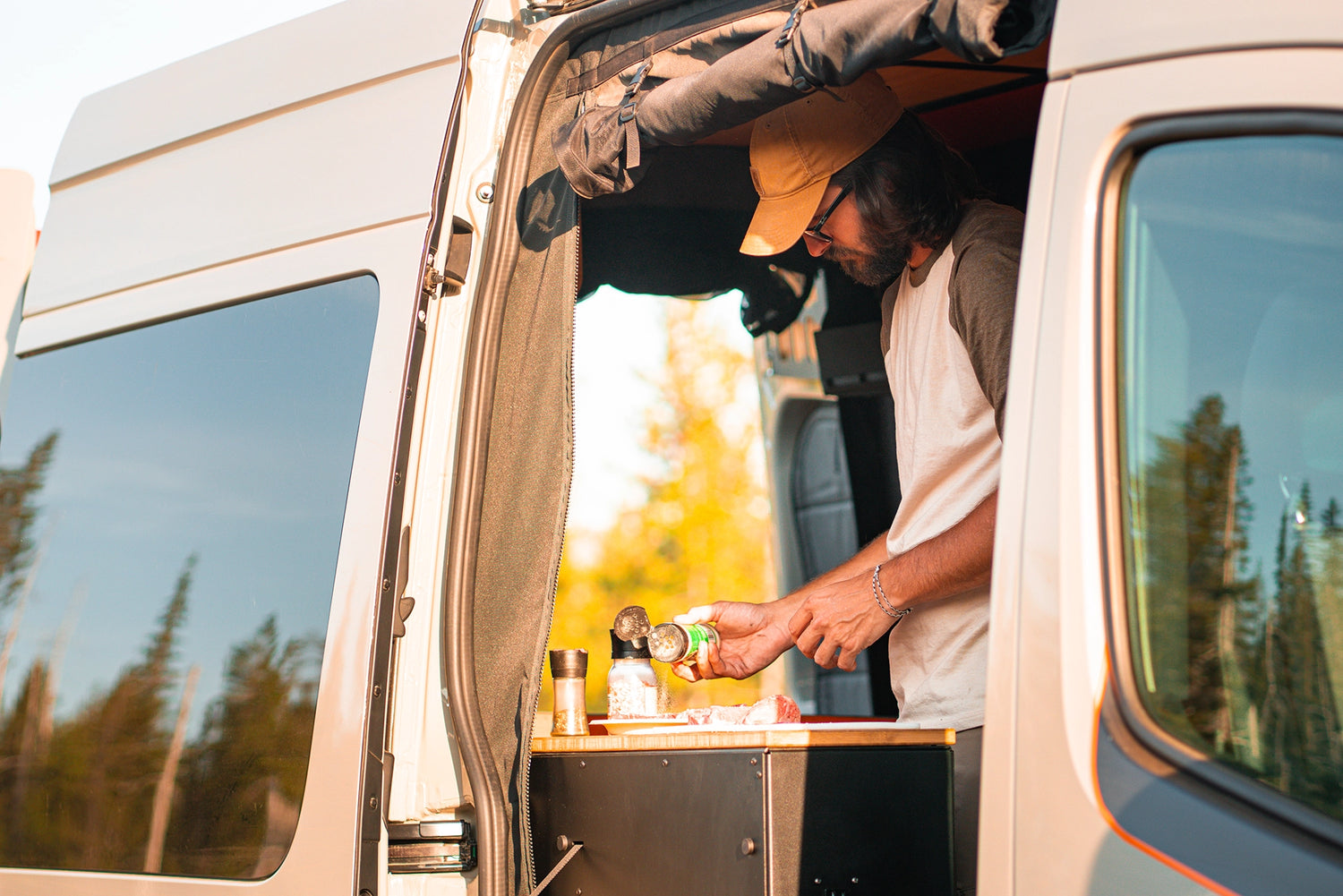 Adventure van set up at a lakeside campground, showcasing off‑grid vanlife and camping gear