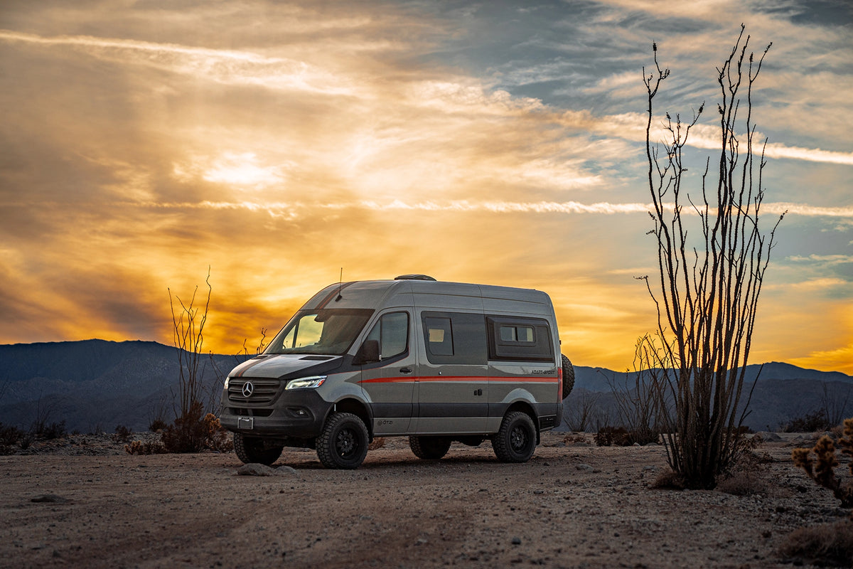 Otzi adventure van parked in a desert landscape at sunset