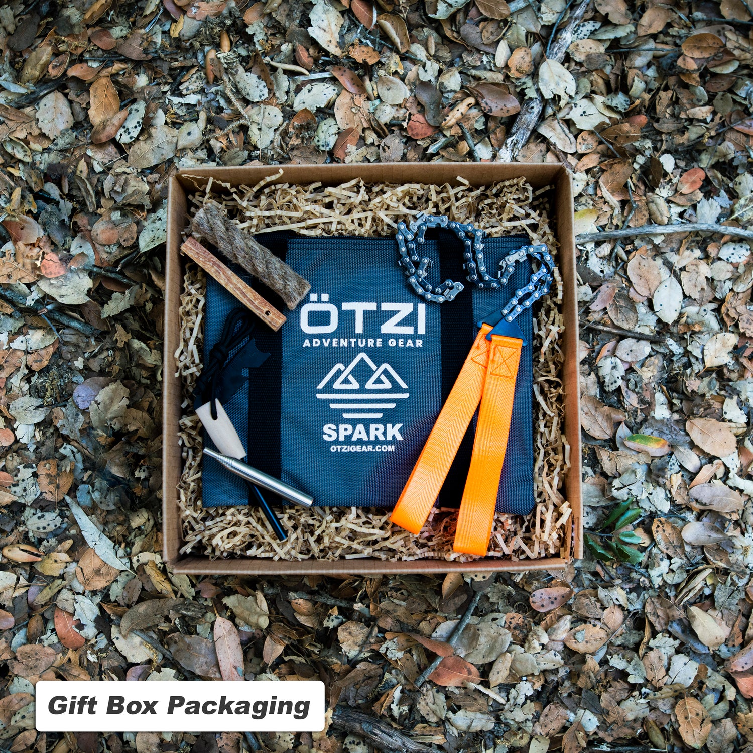 Ötzi adventure gear spark kit with fire starter tools in gift box on forest floor