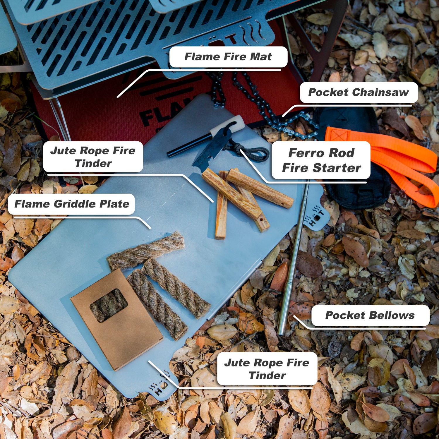 Outdoor fire starter kit with ferro rod, tinder, pocket chainsaw, bellows, and flame griddle plate on forest ground