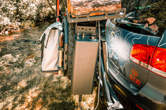 Off-road vehicle with mounted gear carrier holding a log, storage box, and utility bag
