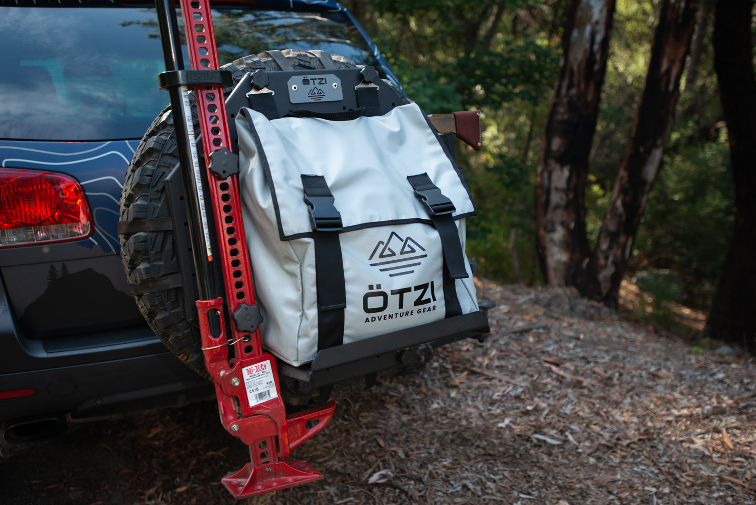 Ötzi adventure gear bag mounted on a spare tire rack at the back of an off-road vehicle.