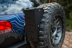 Close-up of a tire-mounted utility plate attached to an off-road vehicle.