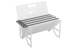 Set of five black grill skewers resting on a compact metal camping grill