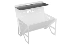 Black metal shelf attachment mounted on a portable camping grill frame.