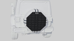 Black octagonal spare tire cover with grid pattern mounted on a white off-road vehicle.