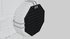 Black octagonal spare tire cover with mounting panel attached to a white off-road vehicle.